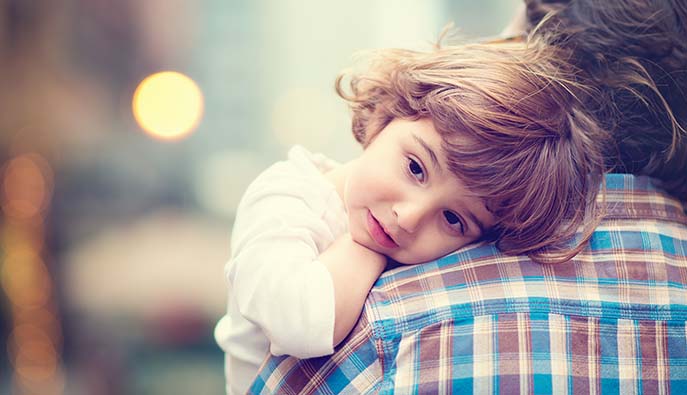 Little girl over man's shoulder