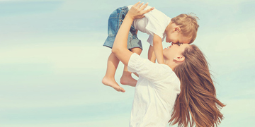 mother lifting sun up outside