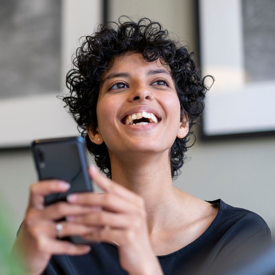 person holding phone and smiling 900x900