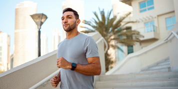 Person outside on a run with a house in the background